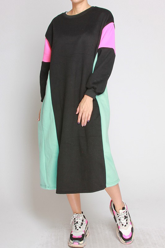 Model rocking black fashion in the fleece-lined color block dress by Liz. Colors are black, pink, and sea green.